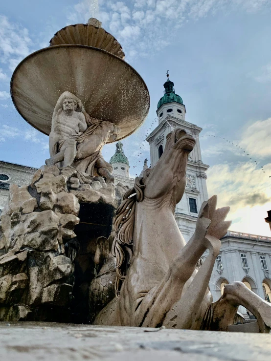 fountain in front of a large white building