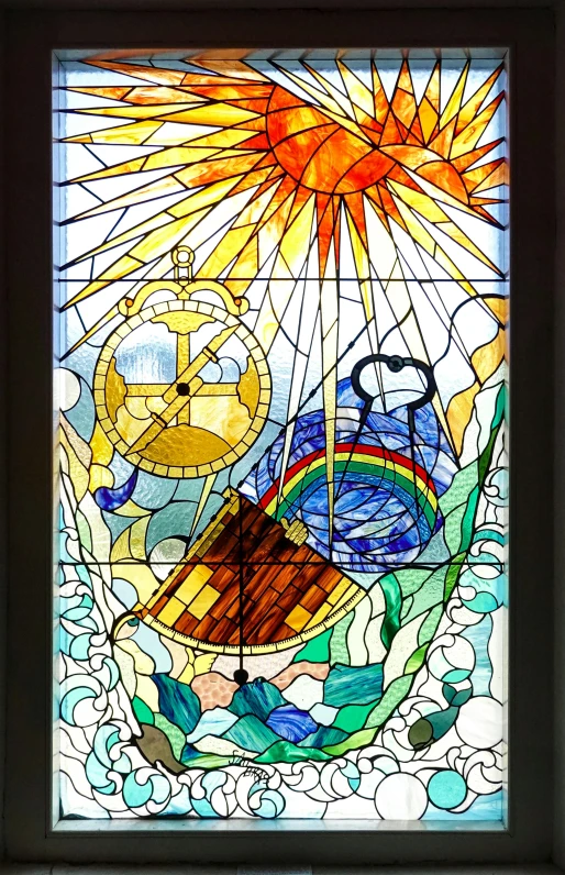 a stained glass window depicting a noah ship with the birth of jesus