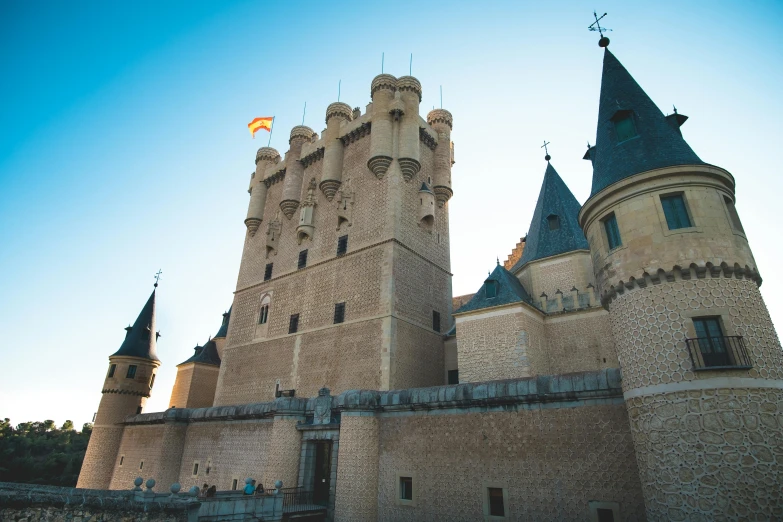 the top of a castle with its towers is seen