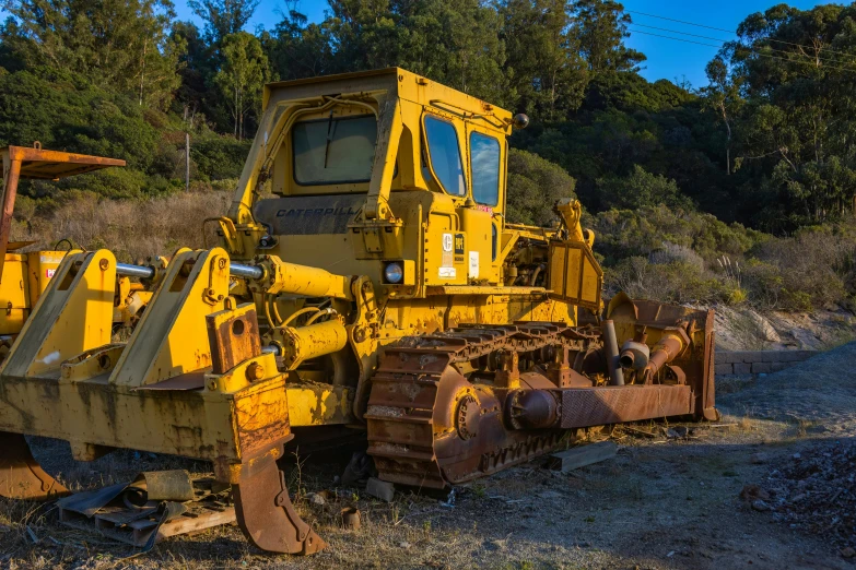 the front of a bulldozer sitting in the dirt