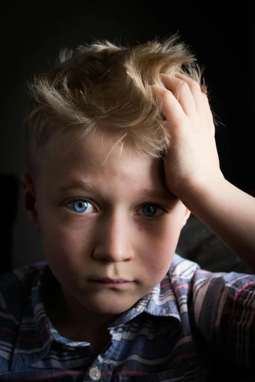 a young child looks off to the right with a skeptical look