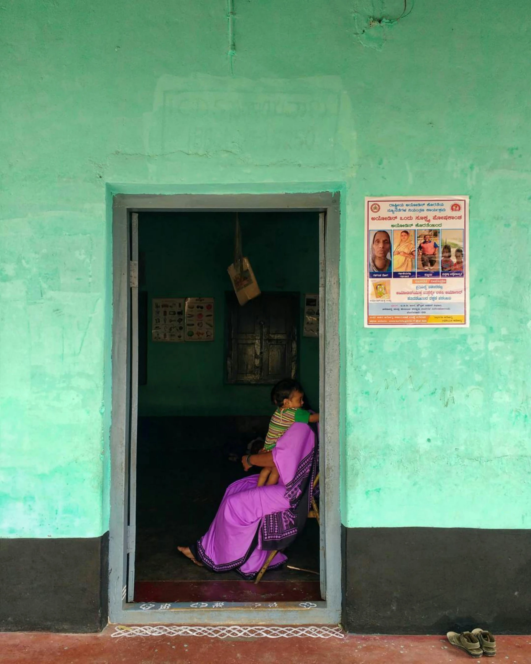 a person sitting in a chair looking through a doorway