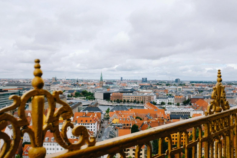 a man sitting on a balcony overlooking the city