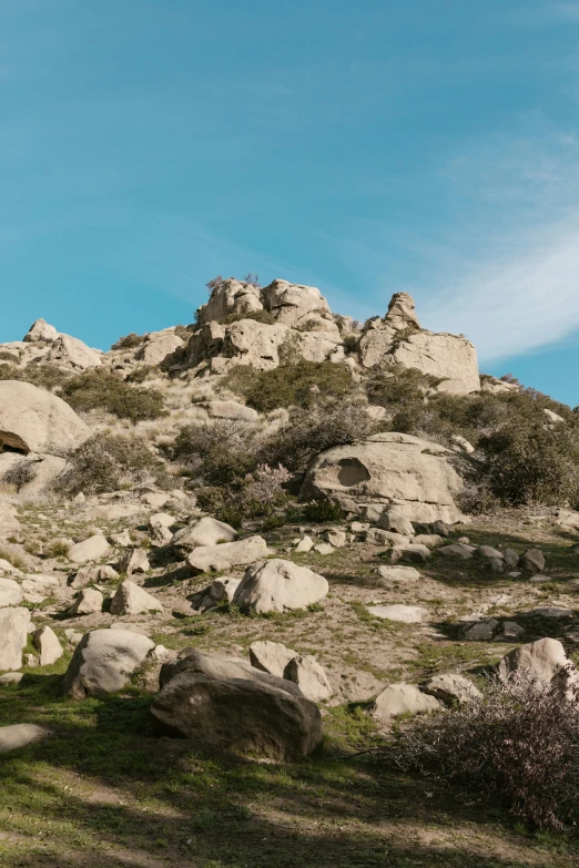 a very old building on top of a mountain with rocks in the foreground