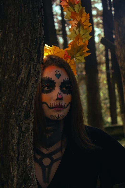 a lady in a white face paint wearing a skeleton hat