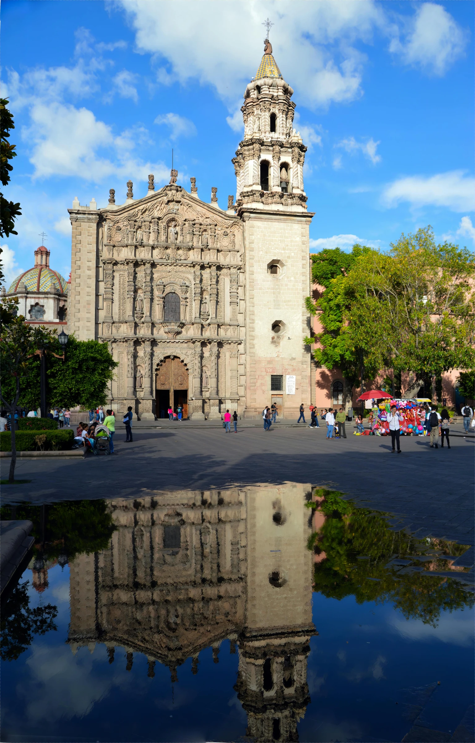 a view of an old church with people walking around