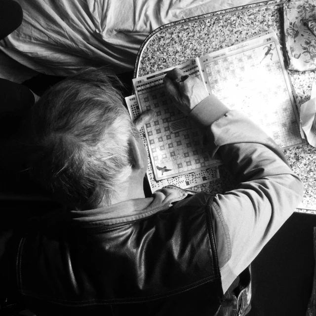 a man is laying on a pillow reading soing