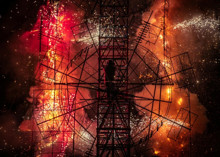 fireworks in the sky near a ferris wheel