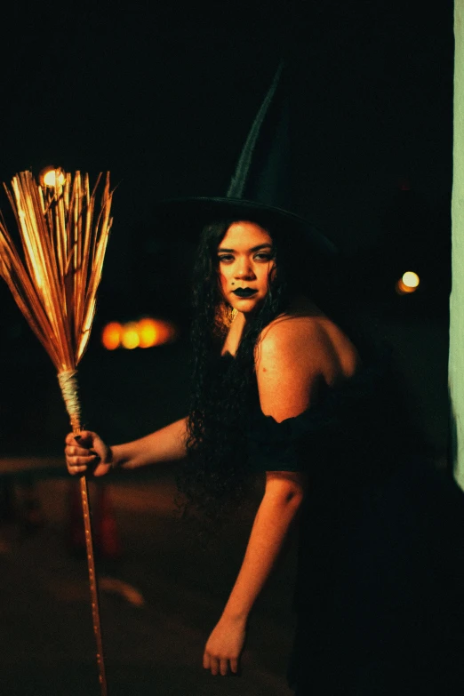 a woman holding a lit up stick and looking at the camera