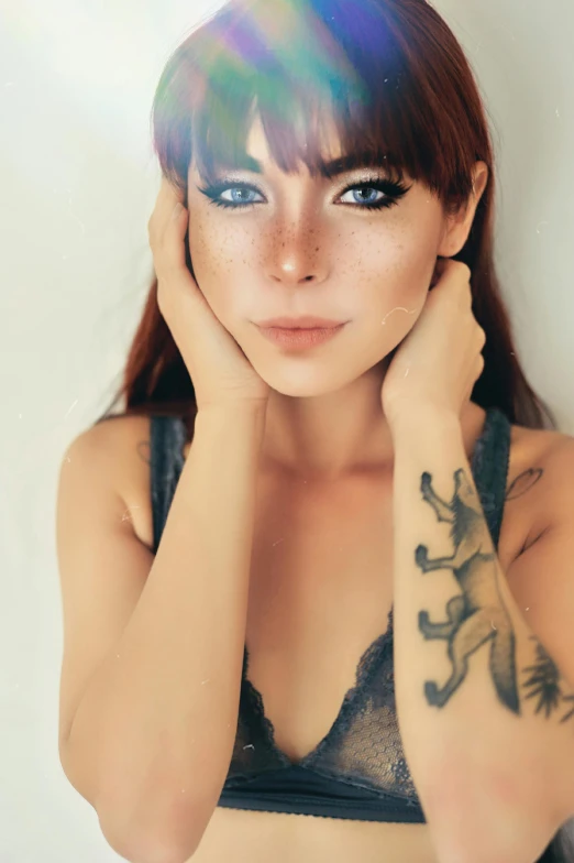 young woman with tattoos and  looking away