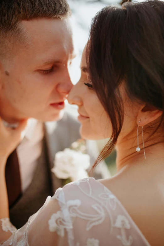 a couple of people with long hair and an ear ring