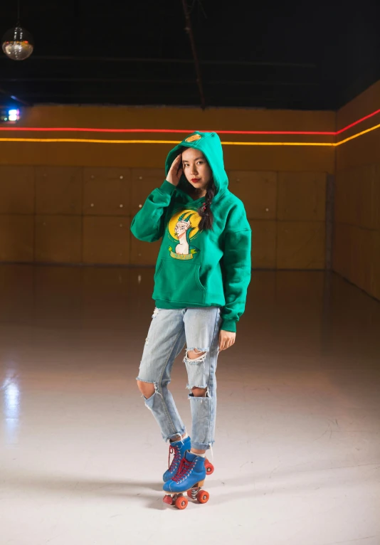 a girl posing with a green jacket on and a skateboard in hand