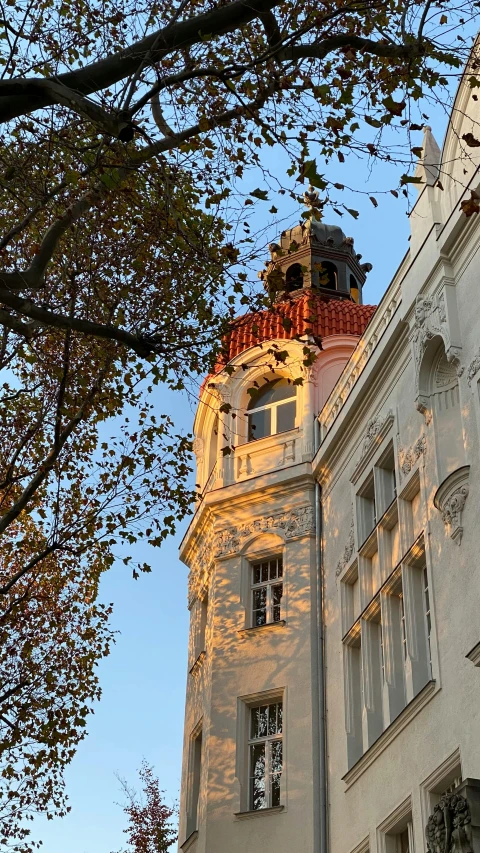 there is an old white building with a red steeple on it