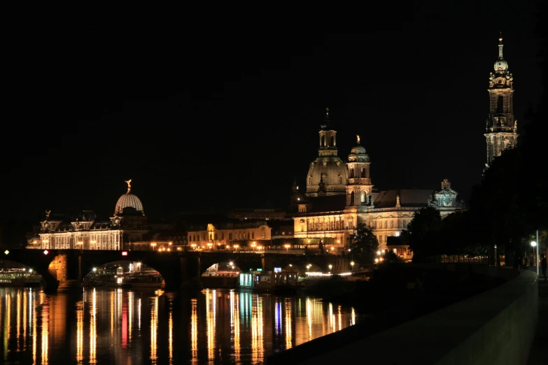 a city lit up in night by a river