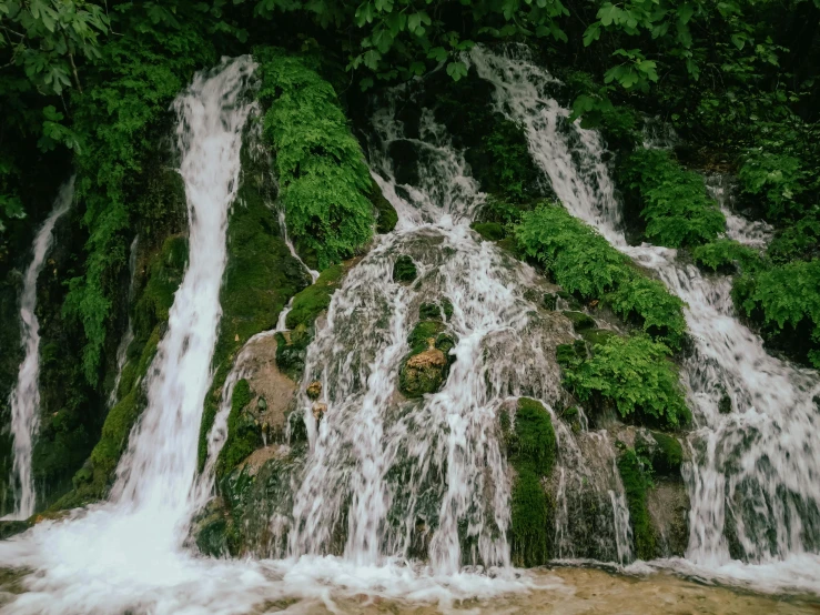 an overhead view of small waterfall in the forest