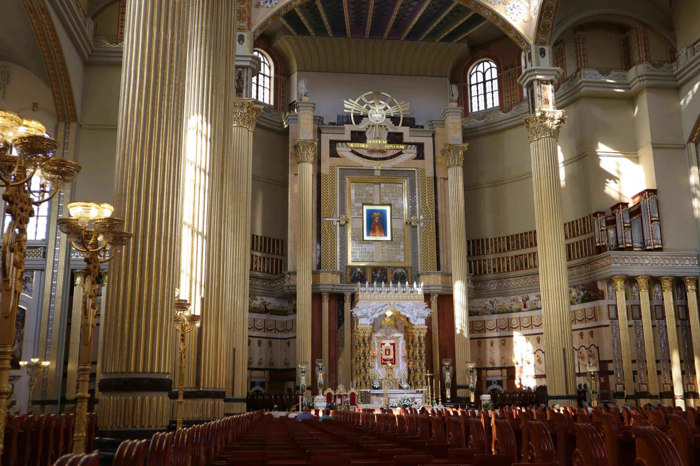 a cathedral filled with rows of pews next to tall columns