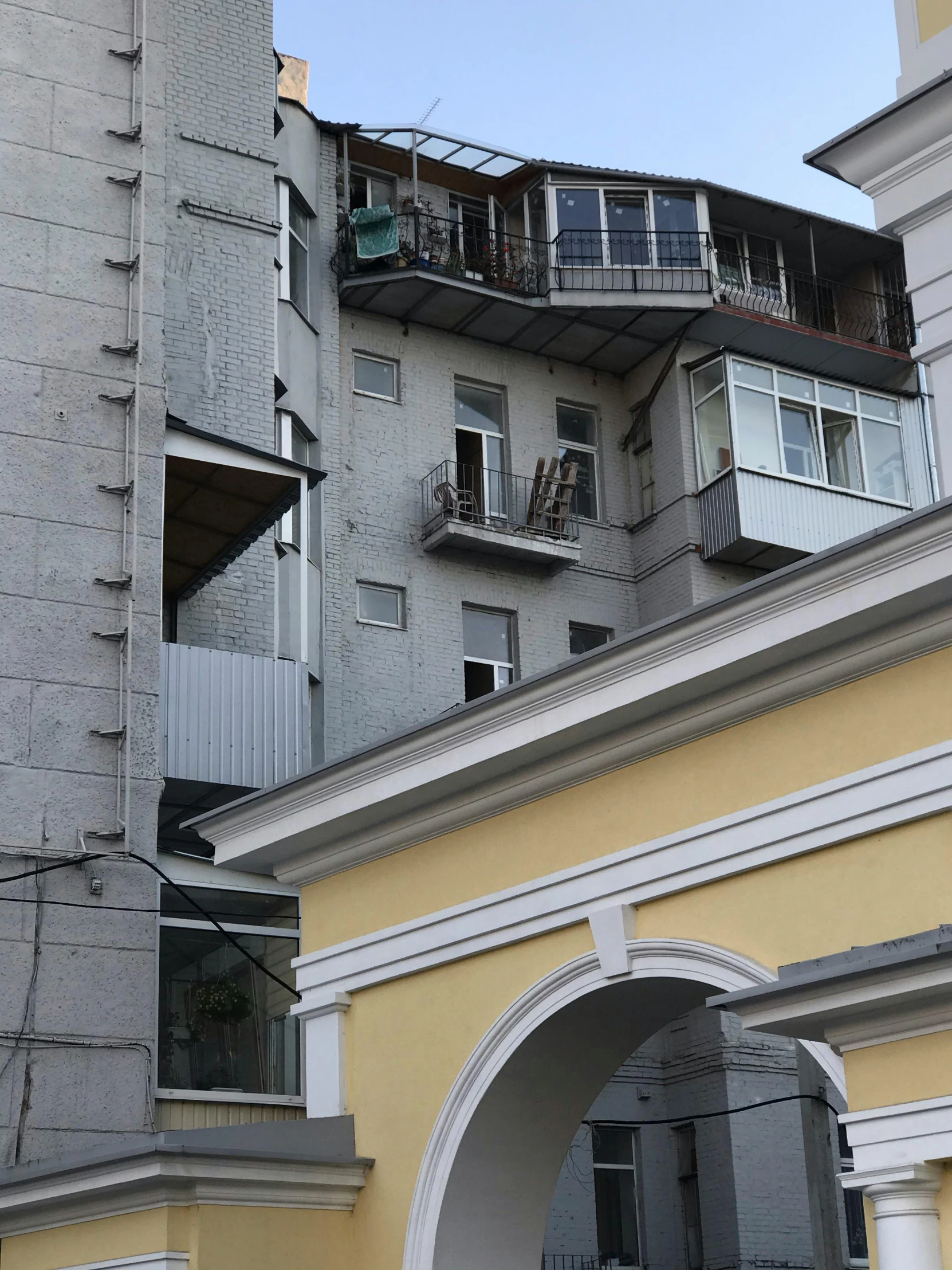 a grey tall building with balconies and balconies on top of it