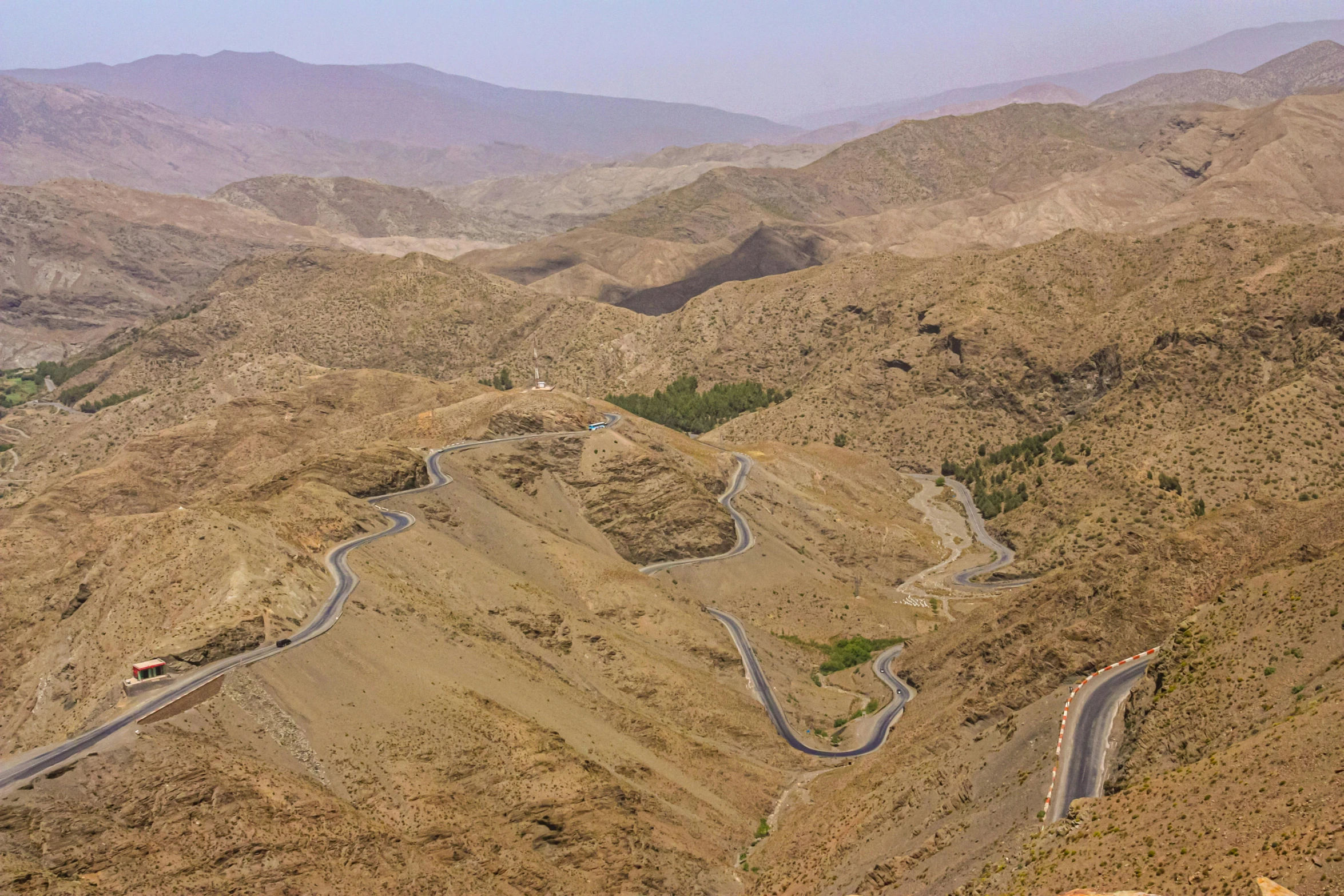 a winding mountain road surrounded by arid terrain