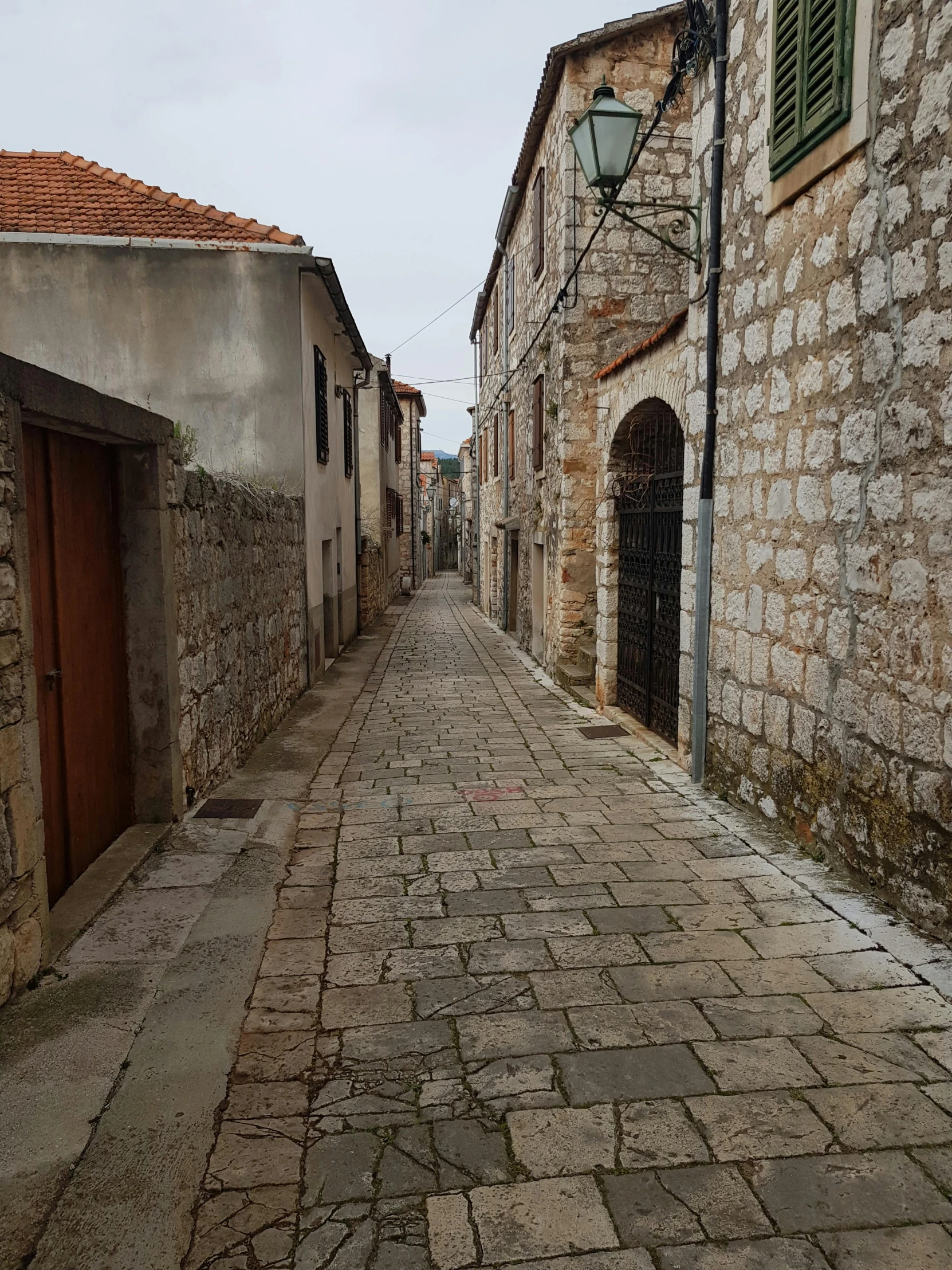 a brick street with some buildings and lights