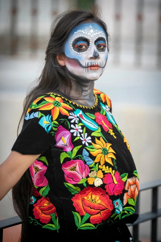 a woman in a colorful skull face paint