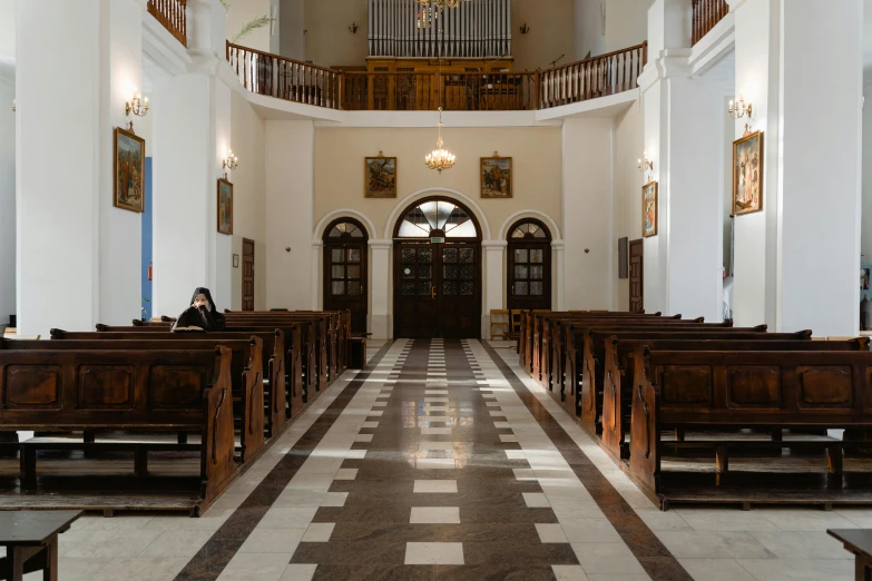 a church is empty, and a woman stands in the front