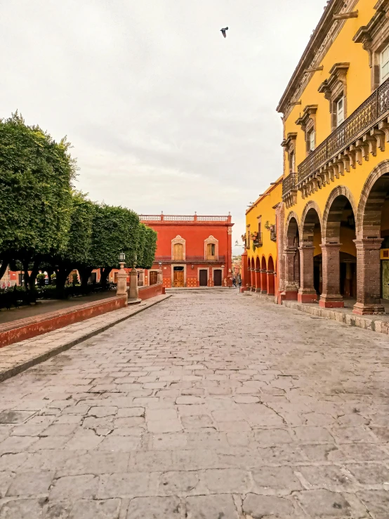 the road is lined with two rows of arches