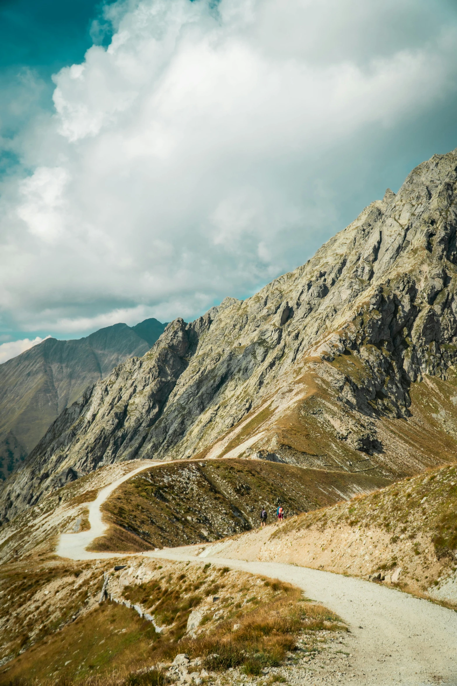 a mountain road going down some steep terrain