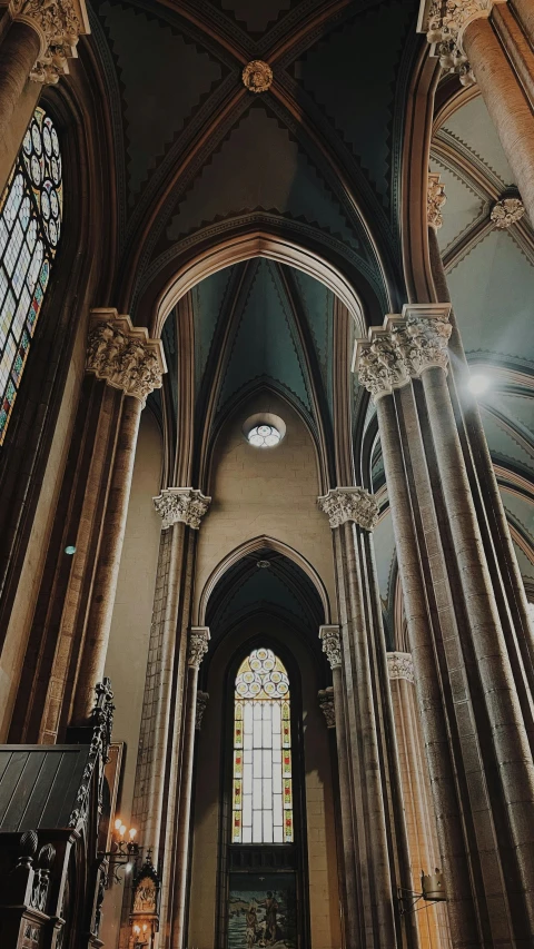 a church has many stone columns and stained glass windows