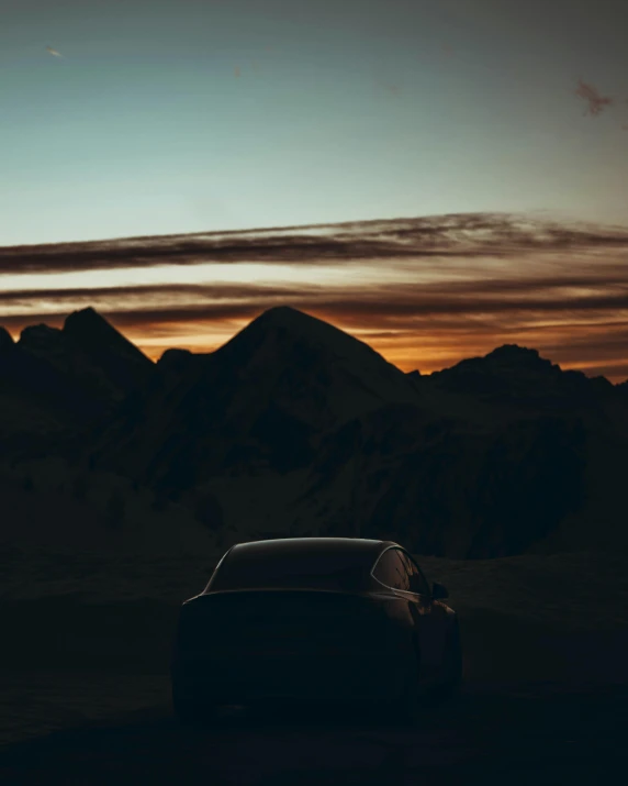 the silhouette of a car and mountains at sunset