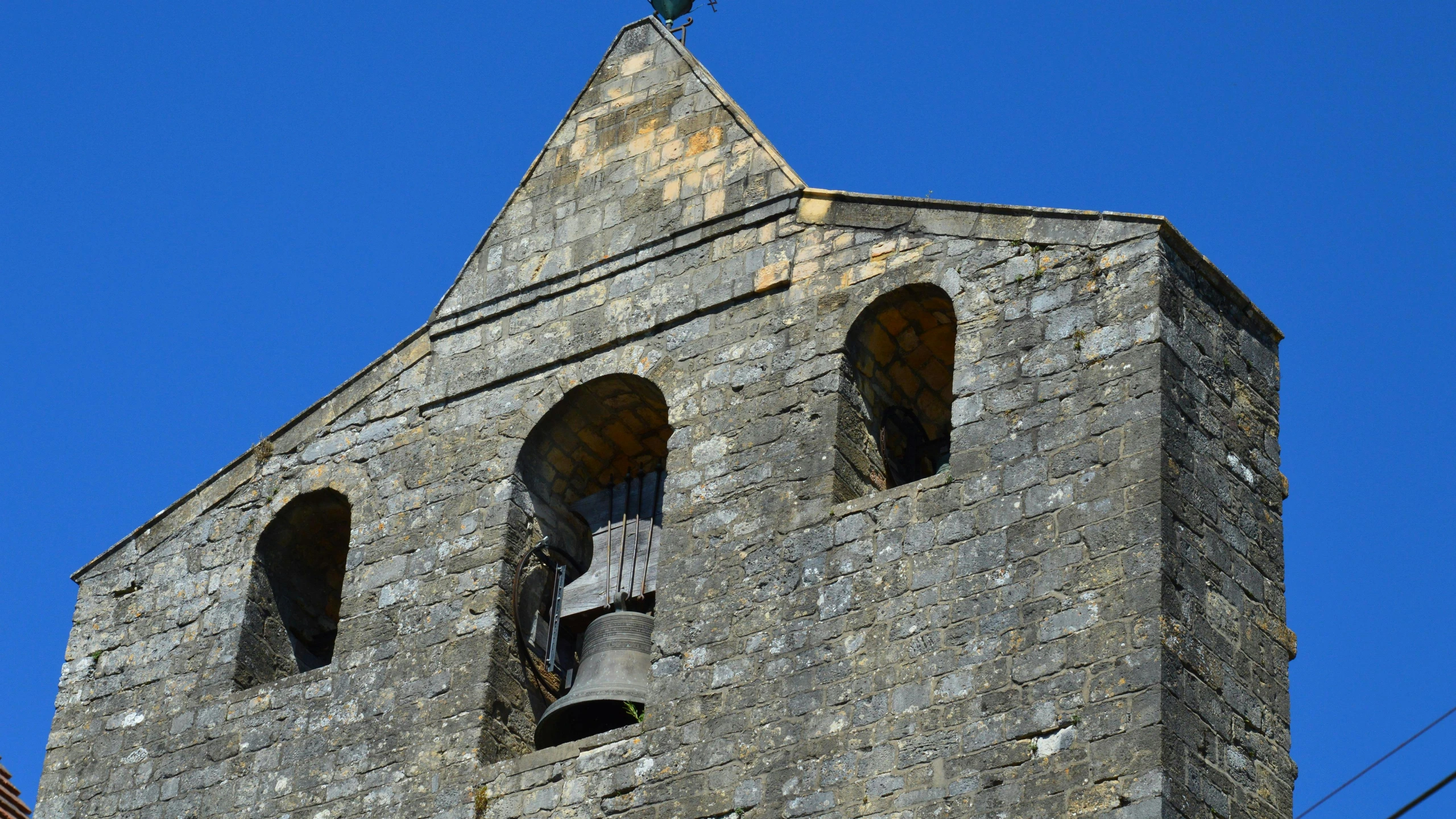 a clock and some statues on the side of a building