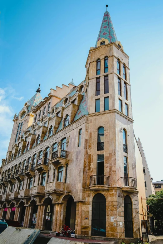 a large building with a very tall steeple on the corner