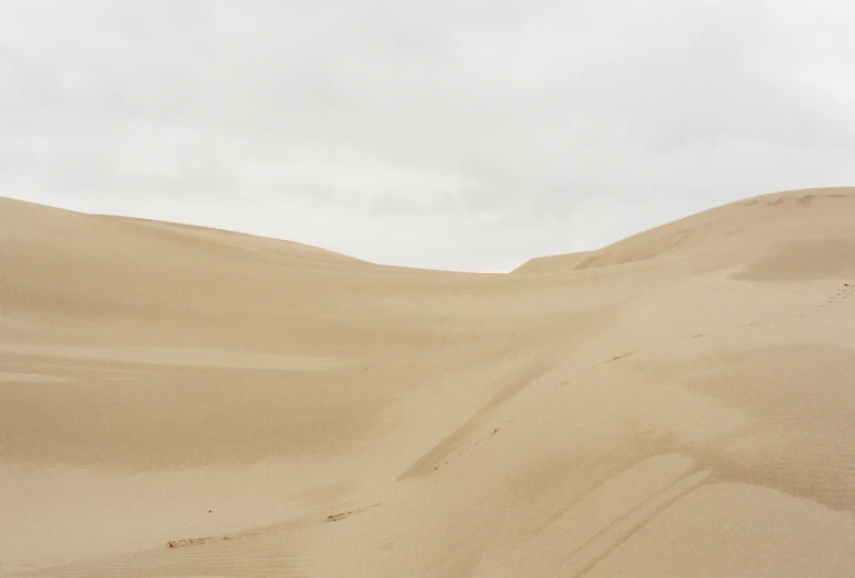 the lone bus is going down the sand dune