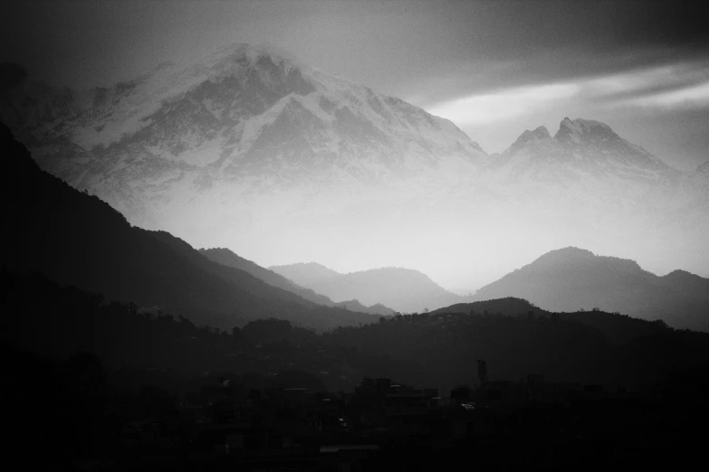 some mountain range that has some type of cloud in it