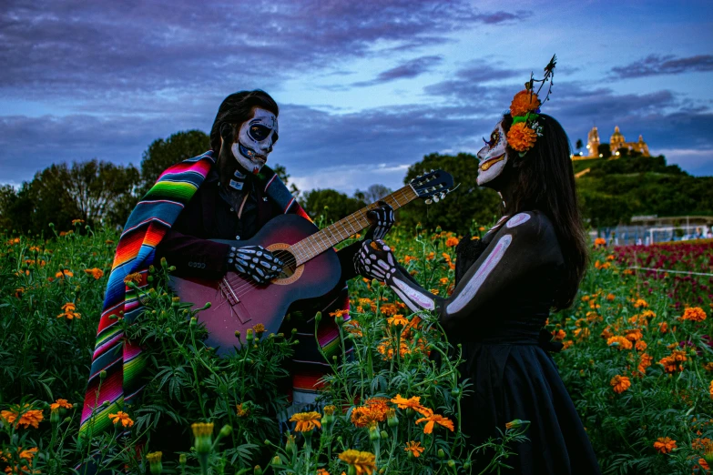 two people with makeup make up playing guitar