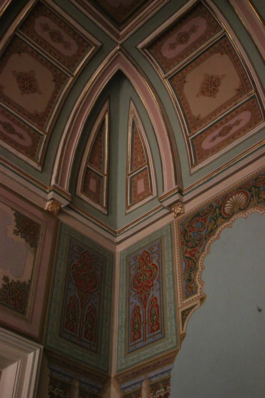 the ceilings of the beautiful room are covered with colorful design