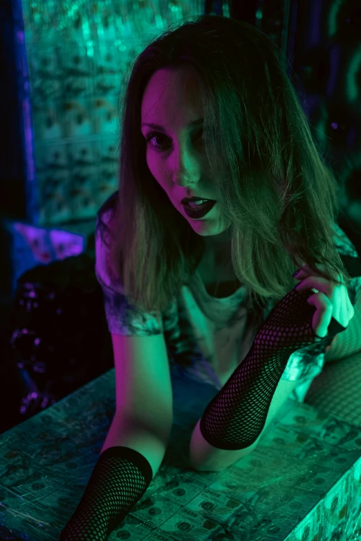 a beautiful woman sitting at a table next to a clock