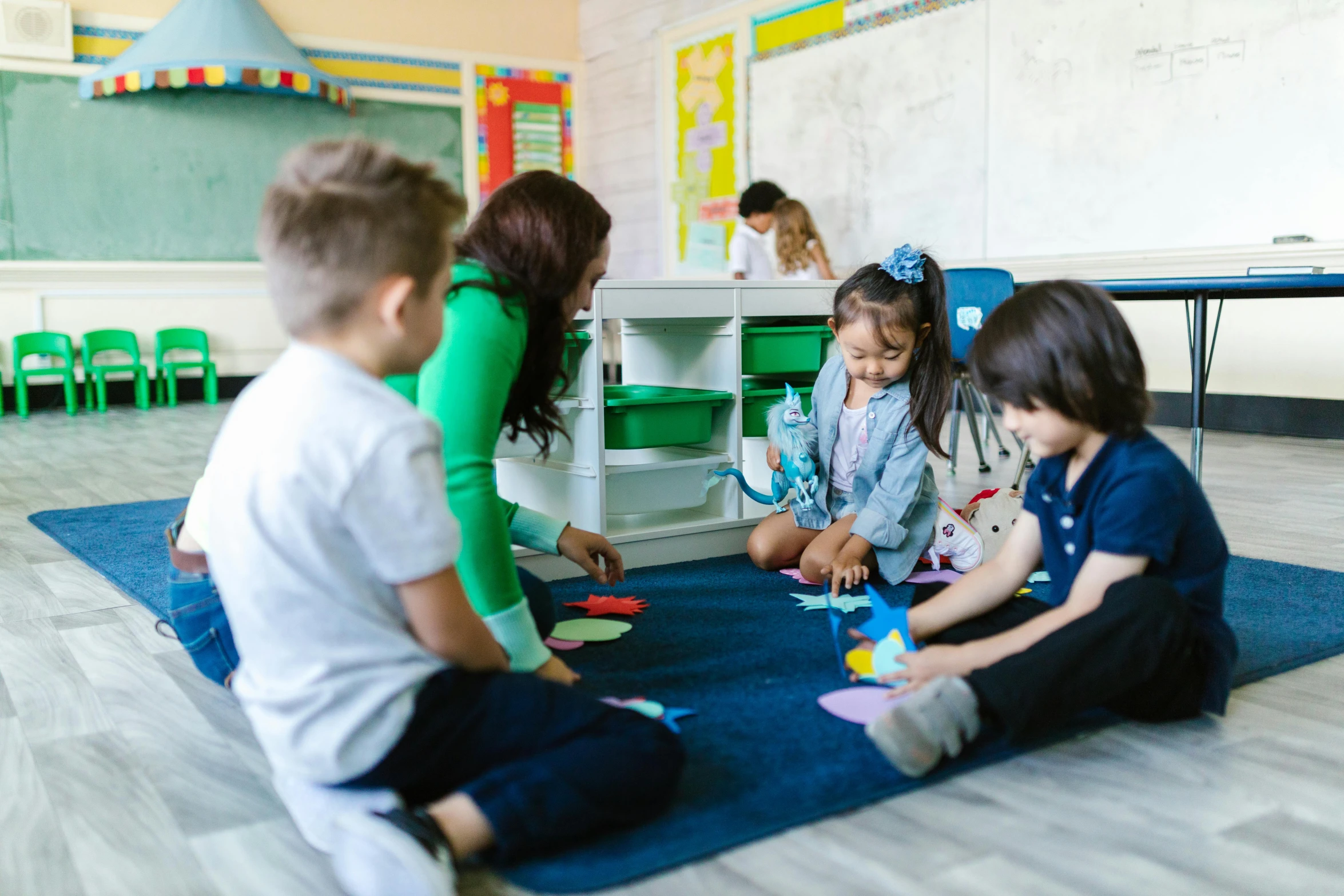 a teacher teaches children how to use their toy vehicles