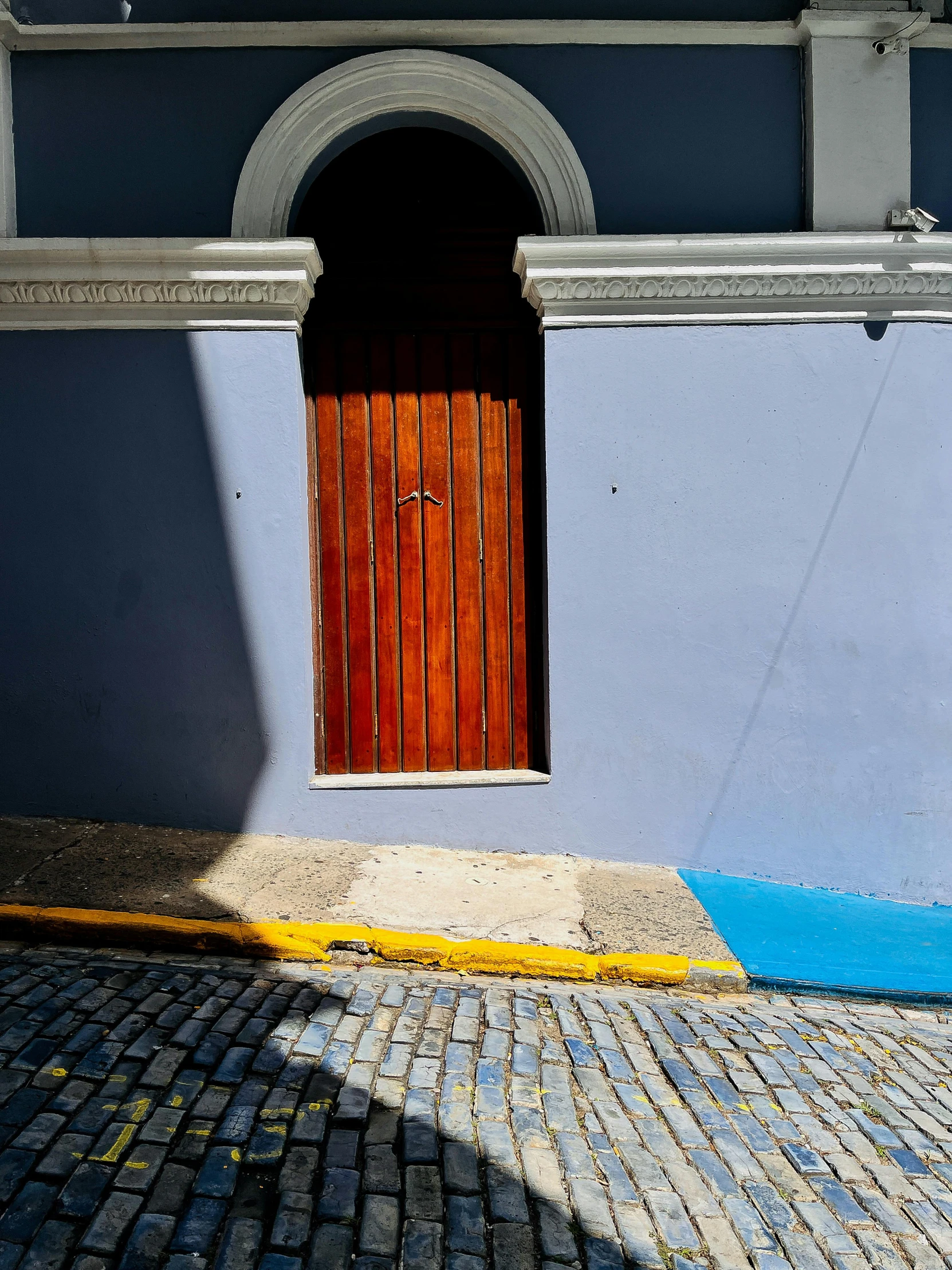 an orange door sits on the side of an empty building