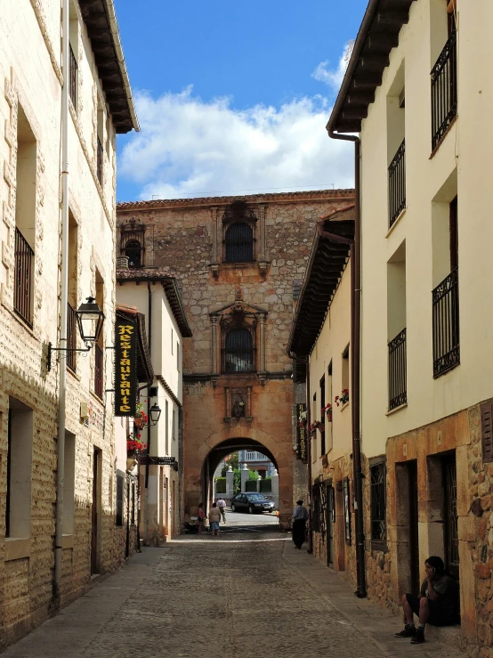 an alley way with people walking in and out