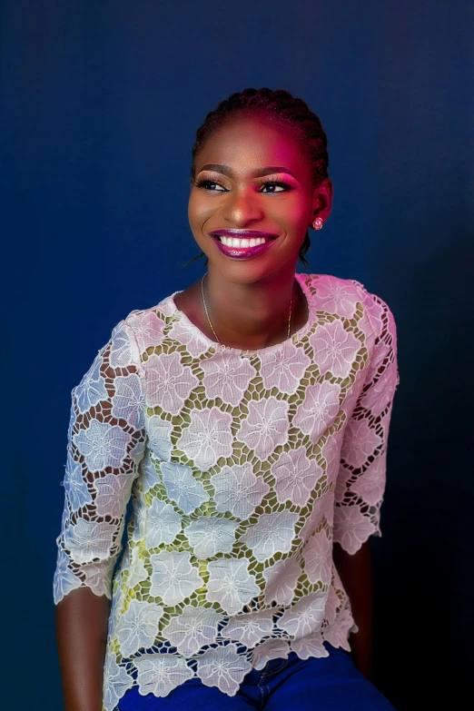 a young woman wearing blue jeans is smiling