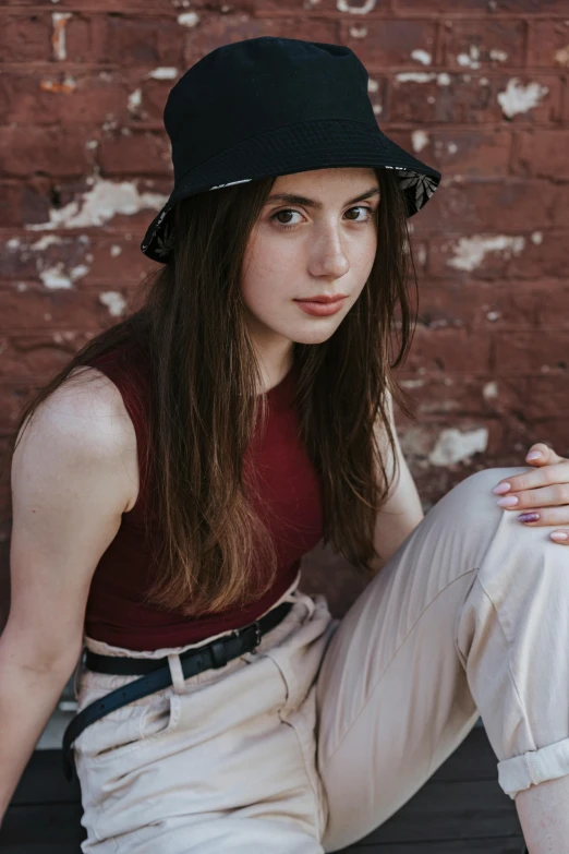 the young lady is posing in a black hat