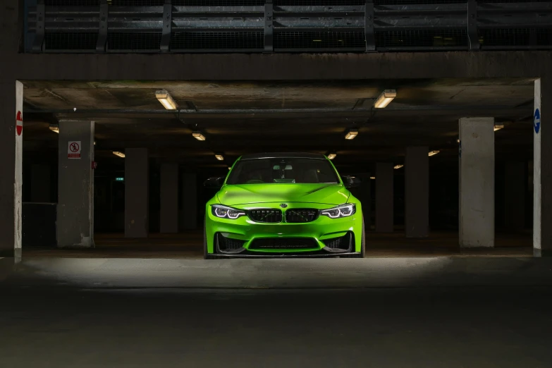 a bright green vehicle is parked in a parking garage