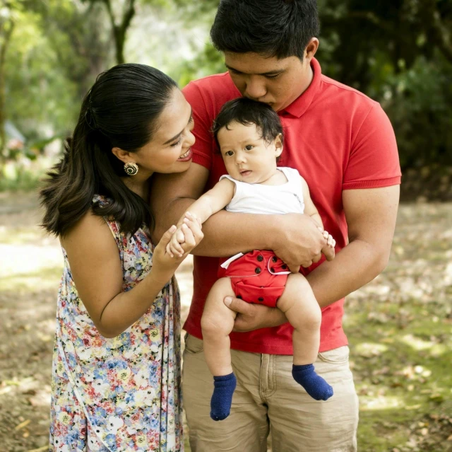 man and woman are standing in front of a child