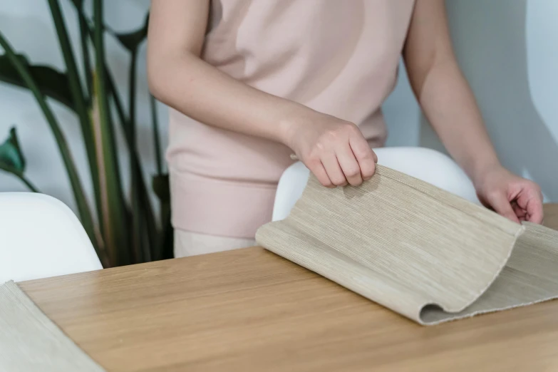 woman laying wood flooring in the process of being prepared