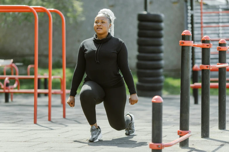 an african american woman running through a playground