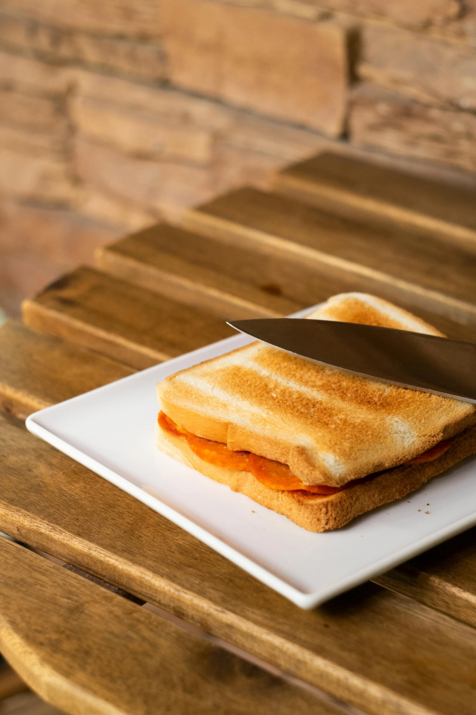 a sandwich is on a plate with a knife