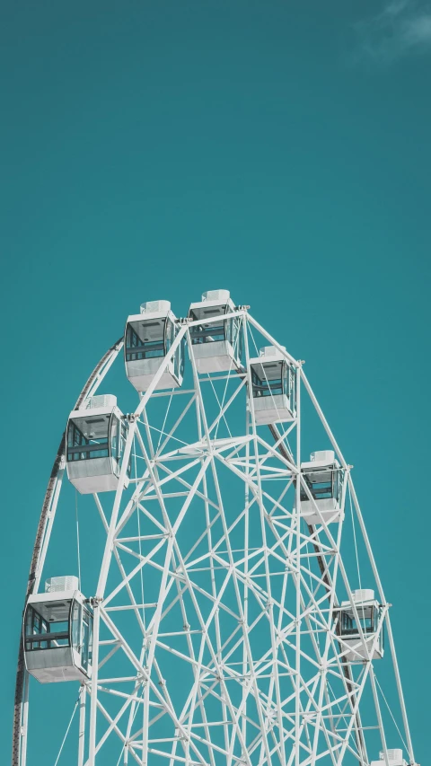 a large white ferris wheel against a blue sky