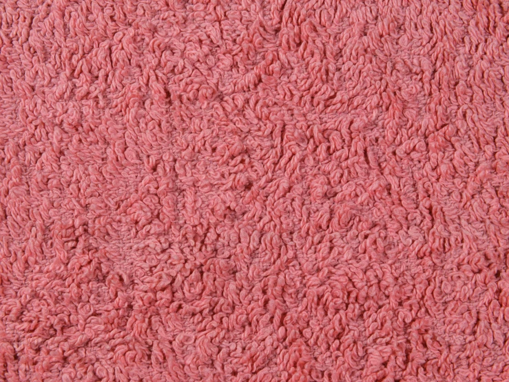 a soft pink colored area rug that has very detailed lines