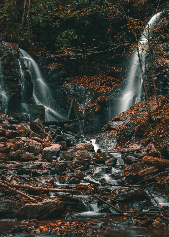 several waterfalls fall into one another in the forest