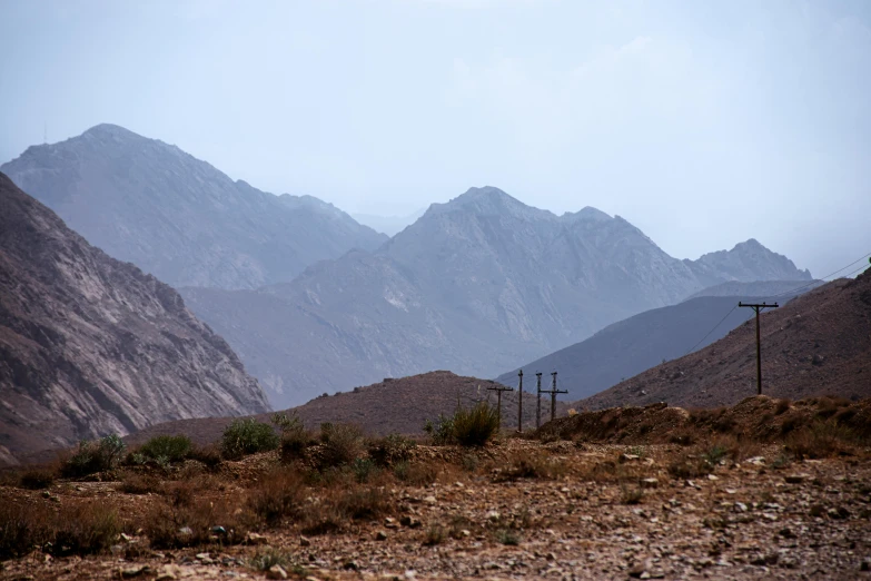 mountains with a small trail between them and dirt ground below